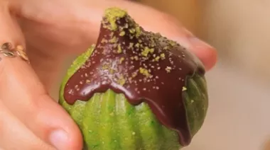 Pistachio modaks drizzled with melted chocolate on a festive plate 5